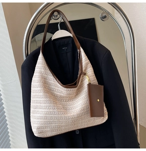Detail of straw woven hobo bag with leather trim and matching detachable small pouch