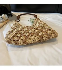 Detail of woven straw tote with round wooden bead handles and two-tone crochet pattern