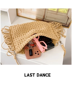 Detail of spacious beige crochet tote interior with fringe decor and daily essentials