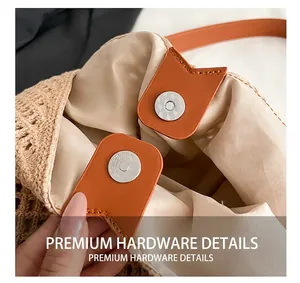 Detail of woven straw tote bag featuring magnetic closure and premium hardware finish
