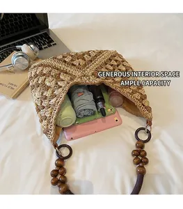 Top-down view of a spacious straw tote bag filled with a tablet, bottle, and umbrella