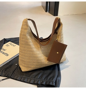 Detail of straw woven hobo bag with brown leather trim and detachable small card pouch