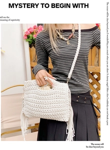 Detail of bohemian white cotton crochet tote bag featuring handmade tassel fringe accents