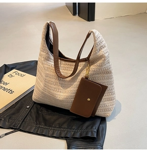 Detail of hand-woven straw tote with brown leather straps and matching coin purse