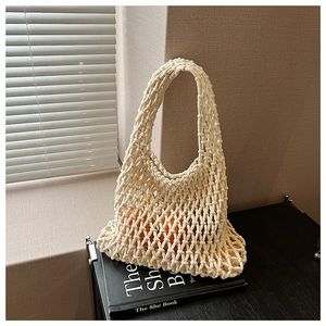 Detail of hollow knit tote bag showing stretchable mesh pattern and beige crochet texture