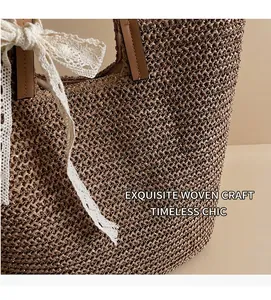 Detailed close-up of woven straw tote bag with lace bow and leather handles
