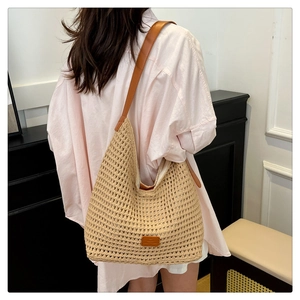 Detailed view of beige crochet hobo bag with brown faux leather strap and textured weave