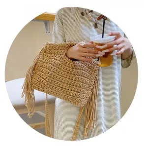 Close-up of beige crochet tote bag featuring long side tassels and woven cotton texture