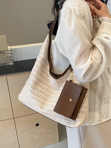 Fashionable oversized straw tote bag with brown leather handles for women's summer style