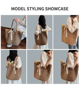 Detail view of large straw tote bag with brown leather handles and white lace bow detail