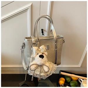 Silver sequin bucket bag featuring a cute plush puppy charm and metallic details