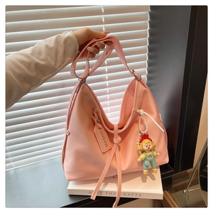 Pink large shoulder bag with MASHK tag and cute cartoon pendant detail