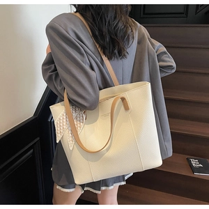 Detail of cream tote bag in lychee leather with brown strap and scarf wrap
