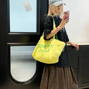 Détail d'un sac cabas en toile jaune vif avec broderie verte History Child élégante