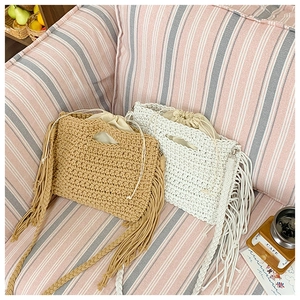 Detailed texture of bohemian crochet tote bags with fringe tassels and inner lining