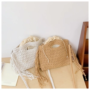 Detail of bohemian cotton crochet tote bag with fringe tassels and inner drawstring pouch