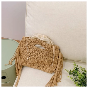 Detail of hand-woven cotton shoulder bag with boho tassels and drawstring lining