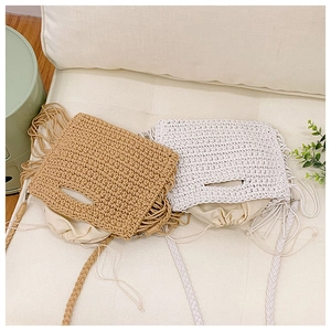 Detail of crochet cotton shoulder bags with tassels and drawstring inner liners