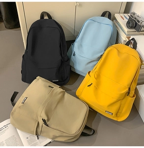 Detail showing high-capacity canvas backpacks in black, blue, yellow, and khaki colors
