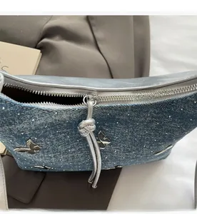 Detailansicht des glatten Silber-Reißverschlusses und Jeansstoffs dieser Schleifen-Tasche