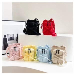 Detailed view of six mini crossbody bags in various colors with bow decoration