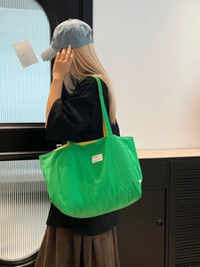 Grand sac cabas matelassé vert avec doublure jaune et étiquette tissée minimaliste