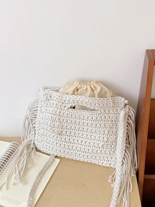 Bohemian style white cotton crochet tote bag with long fringe details and inner pouch