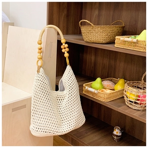 Detail of hand-woven crochet bag with wood bead strap and secure inner lining