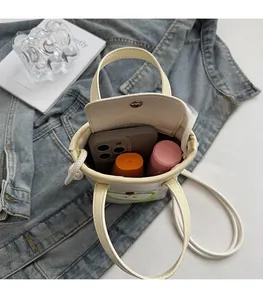 Interior view of off-white mini apple tote showing storage space for phone and lipstick