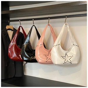 Detailed view of hobo underarm bags with punk rivet star patterns in various colors