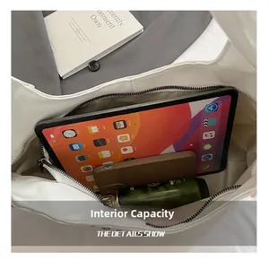 Macro view showing the internal capacity of the white leather shoulder bag with daily items