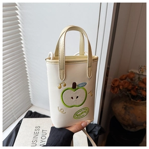 Close-up of off-white apple embroidery and music note detail on fashionable handbag