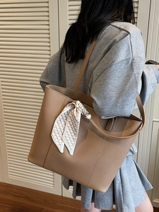 Brown litchi leather tote bag with decorative scarf and elegant shoulder strap design