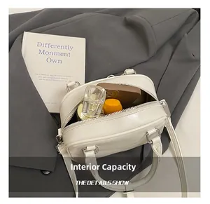 Close-up of cream white handbag interior showing storage capacity for daily essentials