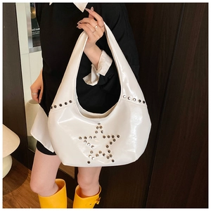 Close-up of white patent leather hobo bag with silver star rivets and Y2K aesthetic