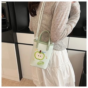 Close-up of light green apple handbag with NICE embroidery and slim shoulder strap
