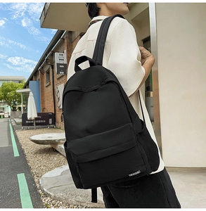 Close-up of durable black nylon backpack featuring large front pocket and padded straps