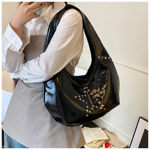 Detail of silver star studs on a black PU leather crescent hobo bag for women