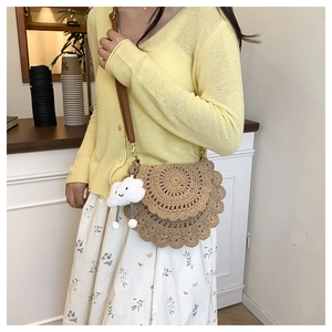 Detail of woven saddle bag with tiered crochet lace and plush cloud charm accessory