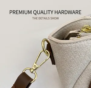 Detailed close-up of light brown denim fabric with premium gold metal hook and zipper