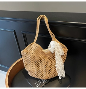 Détail de la texture tissée ajourée et du ruban en dentelle blanche sur le sac en paille