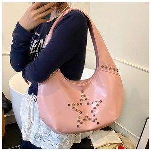 Close-up of pink hobo bag with metallic star studs and glossy faux leather texture