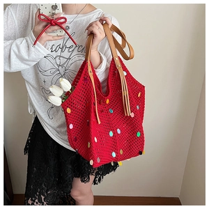 Détail du sac cabas en tricot rouge avec paillettes colorées et anses en cuir