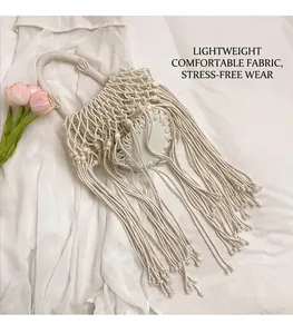 Detail of off-white macramé bucket bag with wooden beads and long bohemian tassels