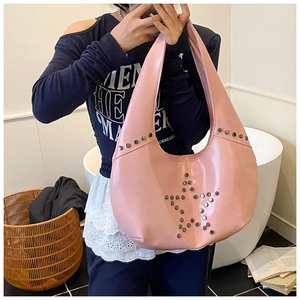 Detail of pink Y2K hobo bag featuring silver metal star studs and retro punk design
