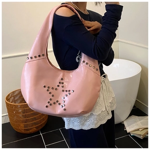 Detailed view of pink leather hobo bag with silver star-shaped metal rivet accents