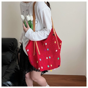 Detail of red crochet tote bag with colorful sequins and brown faux leather straps