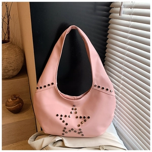Detailed view of pink leather hobo bag with grey metal star-shaped rivet decoration