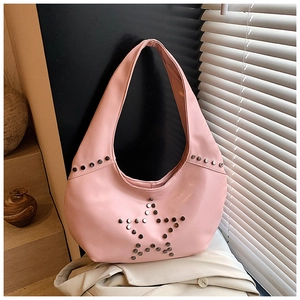 Detail of pink hobo shoulder bag with metal star rivets and punk rock aesthetic