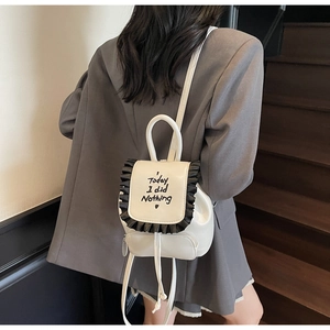 Mini cream PU backpack with black ruffled trim and Today I did Nothing embroidery detail